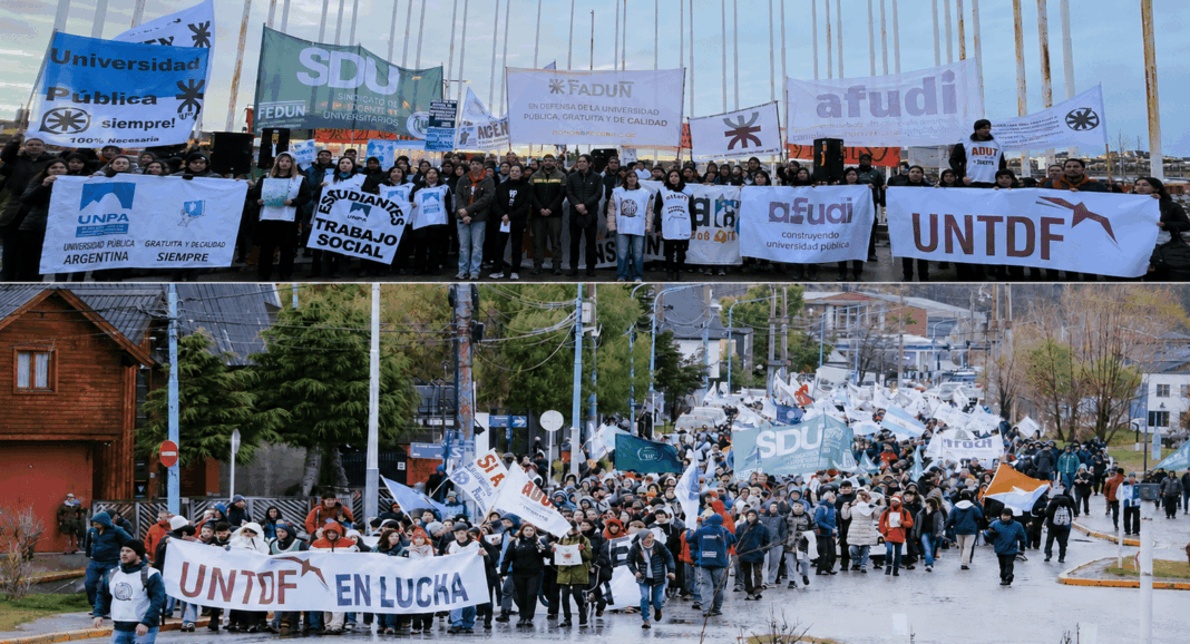 Multitud marchando por calles de Ushuaia con carteles en defensa de la educación pública